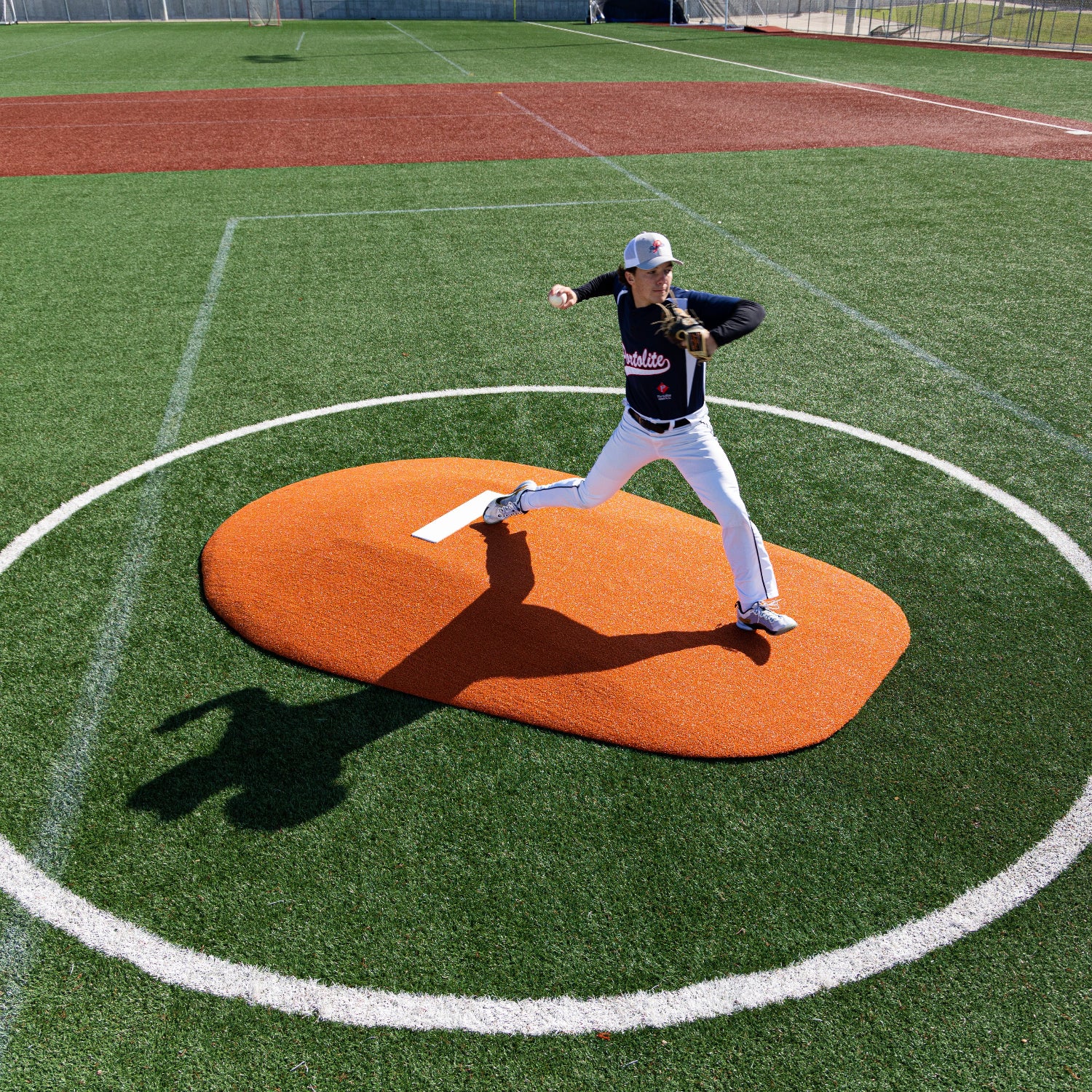 Overhead shot of a pitcher pitching on a 10" Portolite Mound