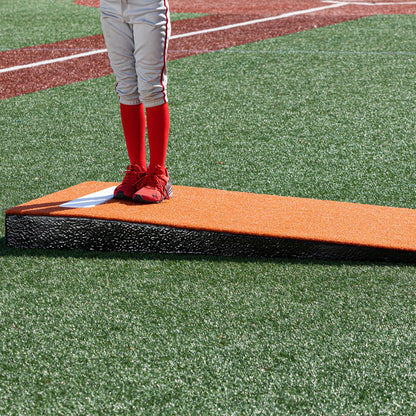 Pitching using a clay colored junior  practice mound