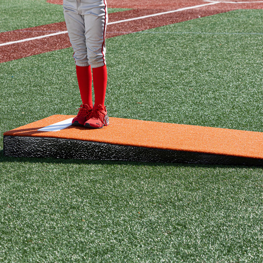 Pitching using a clay colored junior  practice mound