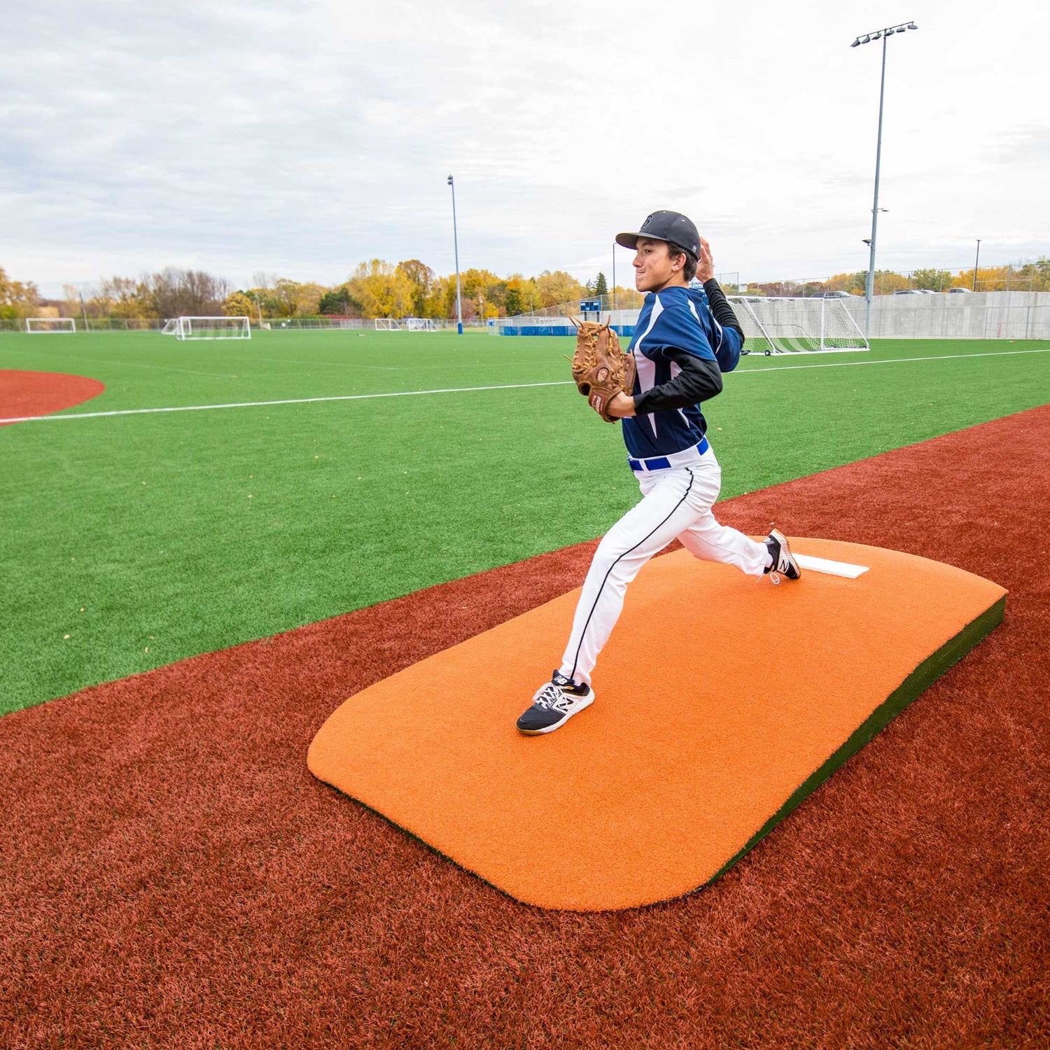 Pitcher warming up using a 1 piece practice mound
